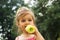 Little girl portrait eating pepper outdoor