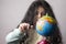 Little girl portrait holding a globe in hand and spin it by right hand