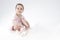 Little Girl Posing as Ballerina in Toes. Against White Background