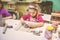 Little Girl At Pottery Workshop Working With Clay