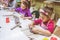 Little Girl At Pottery Workshop Working With Clay