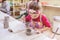 Little Girl At Pottery Workshop Working With Clay