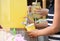 Little girl pouring natural lemonade into cup. Summer refreshing drink