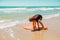 Little girl practicing surfing position at beach.