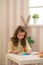 Little girl preparing for Easter - painting, drawing colored in the Room