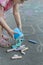 Little girl preparing for sidewalk chalk drawing on tarmac surface