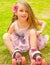 Little girl preschool beginner in roller skates, in a grass background