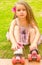 Little girl preschool beginner touching her roller skates, in a grass background