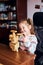 Little girl preschooler playing with wooden blocks toy building a house