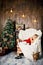 Little girl pretending to be sleeping on an armchair near a Christmas tree to meet Santa when he brings presents