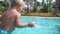 Little girl pulls mother finger splashes and walks in pool