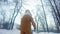 Little girl pulls a snow sled on snow covered park pathway