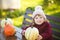 Little girl with pumpkin harvest, Thanksgiving.