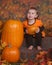 Little girl with pumpkins