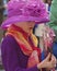 Little girl in a purple flowered bonnet holding a fan at the Fifth Avenue Easter Parade.