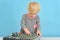 A little girl pushes buttons on a music mixing console