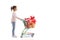 Little girl pushing presents in a mini shopping cart