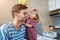 Little girl putting golden crown on dad`s head