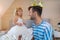 Little girl putting golden crown on dad`s head