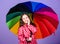 Little girl in raincoat. happy little girl with colorful umbrella. rain protection. Rainbow. autumn fashion. cheerful