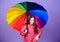 Little girl in raincoat. rain protection. Rainbow. autumn fashion. cheerful hipster child in positive mood. happy little