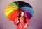 Little girl in raincoat. rain protection. Rainbow. autumn fashion. cheerful hipster child in positive mood. happy little