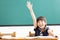 little girl raised hands in classroom