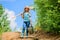 Little girl on rancho. summer farming. farmer little girl. garden tools, shovel and watering can. kid worker sunny