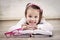 Little girl reading book and smiling