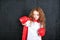 Little girl in red boxing gloves showing aggressive face express