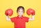 little girl with red boxing gloves on yellow background