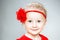 Little girl in red dress with red flower