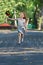 Little girl with red hair runs with windmill