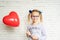 Little girl with red heart shaped baloon, Valentine's day background