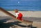 Little girl in red overralls climbing up slide