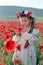 Little girl on red poppy field