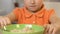 Little girl refusing to eat oatmeal, feeling disgust, healthy nutrition for kids