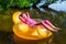 Little girl relaxes in an inflatable chair, floating on the water