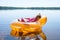 The little girl is resting in an inflatable chair, floating on the water