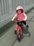 Little girl rides a balance bike