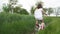 Little girl rides a bicycle on a scenic rural road