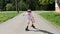 Little girl rides roller skates outdoor