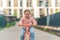 Little girl riding balance bike in the courtyard of the residence in Prague, Europe