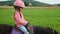 Little girl riding a pony in countryside