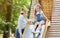 Little Girl Riding Slide Playing With Babysitter On Playground Outdoor