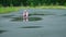 Little Girl Rinsing Hands in the Puddle