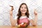 Little girl with roasted chicken wings and thumb up