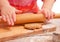 Little girl rolling a gingerbread dough