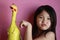 Little girl with rubber chicken