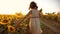 Little girl running across the field with sunflowers at sunset. slow motion video. girl runner in the field at lifestyle